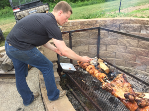 Tyler applying the BBQ rub to the chickens.